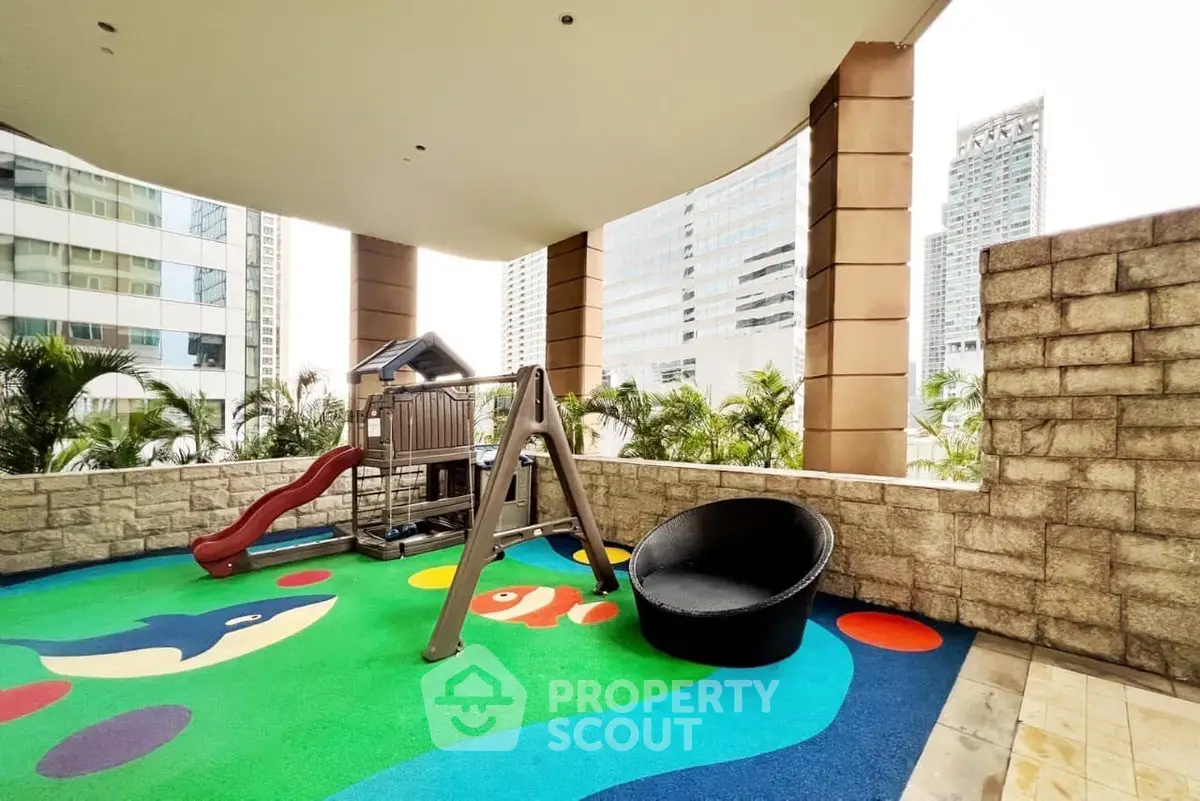 Vibrant outdoor play area with colorful flooring and modern city backdrop
