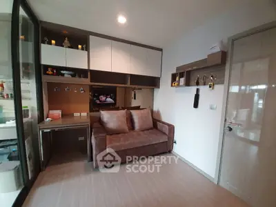 Cozy living room with modern sofa and built-in storage, ideal for compact spaces.