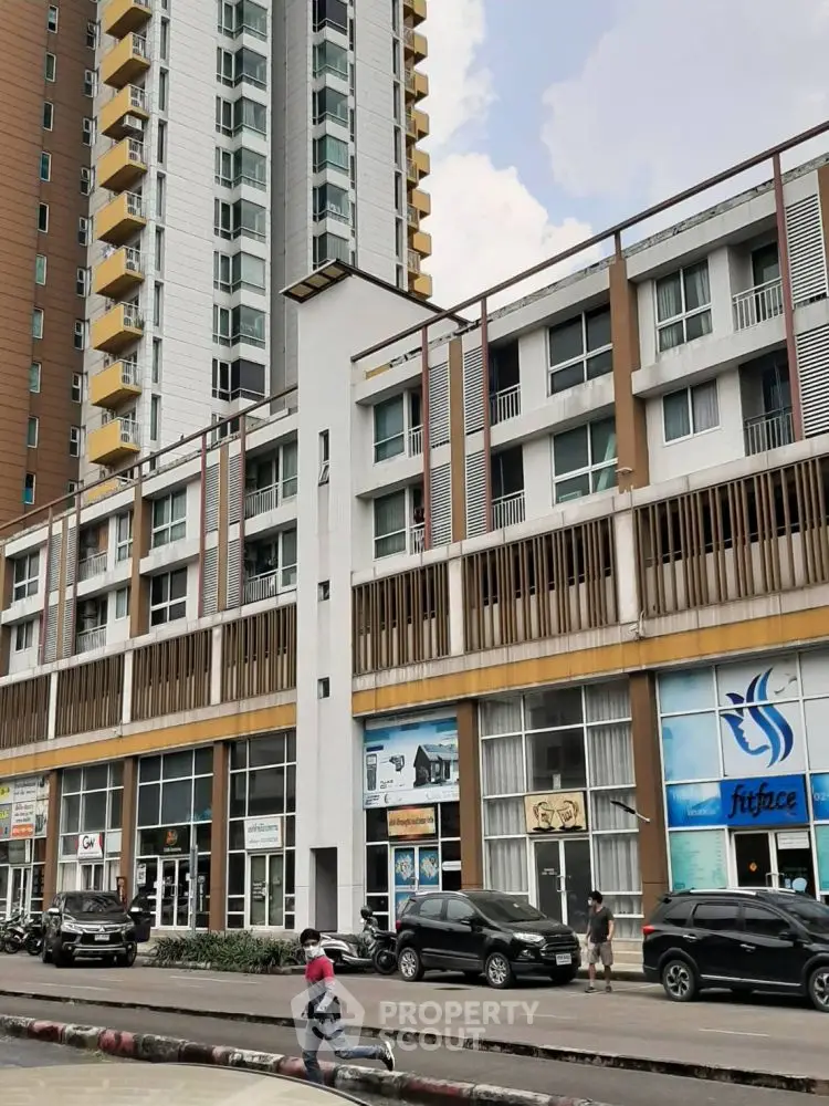 Modern urban building with commercial spaces and residential units, showcasing contemporary architecture.