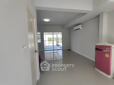 Spacious living room with glossy tiled floor and large window view
