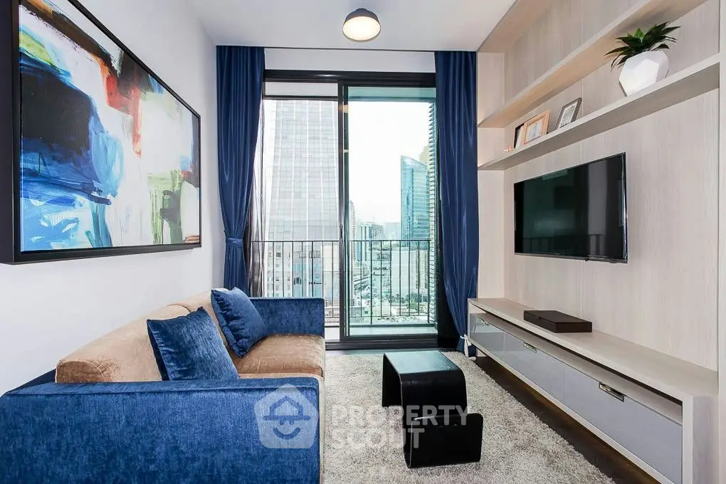 Modern living room with blue sofa, wall-mounted TV, and city view balcony.