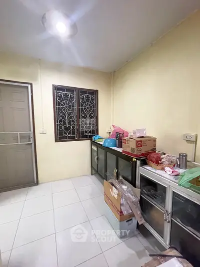 Cozy kitchen space with tiled floor and ample storage, perfect for culinary enthusiasts.