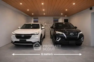 Spacious 6-meter garage with two parked cars, featuring modern lighting and sleek design.