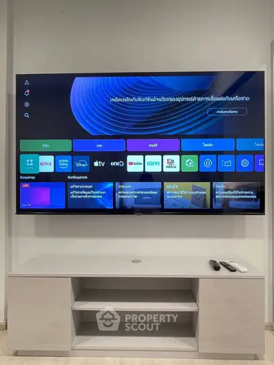 Modern living room with sleek TV setup and stylish console.