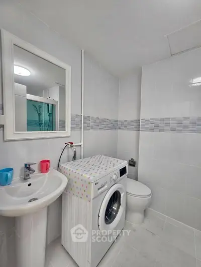 Modern bathroom with washing machine and stylish tiles