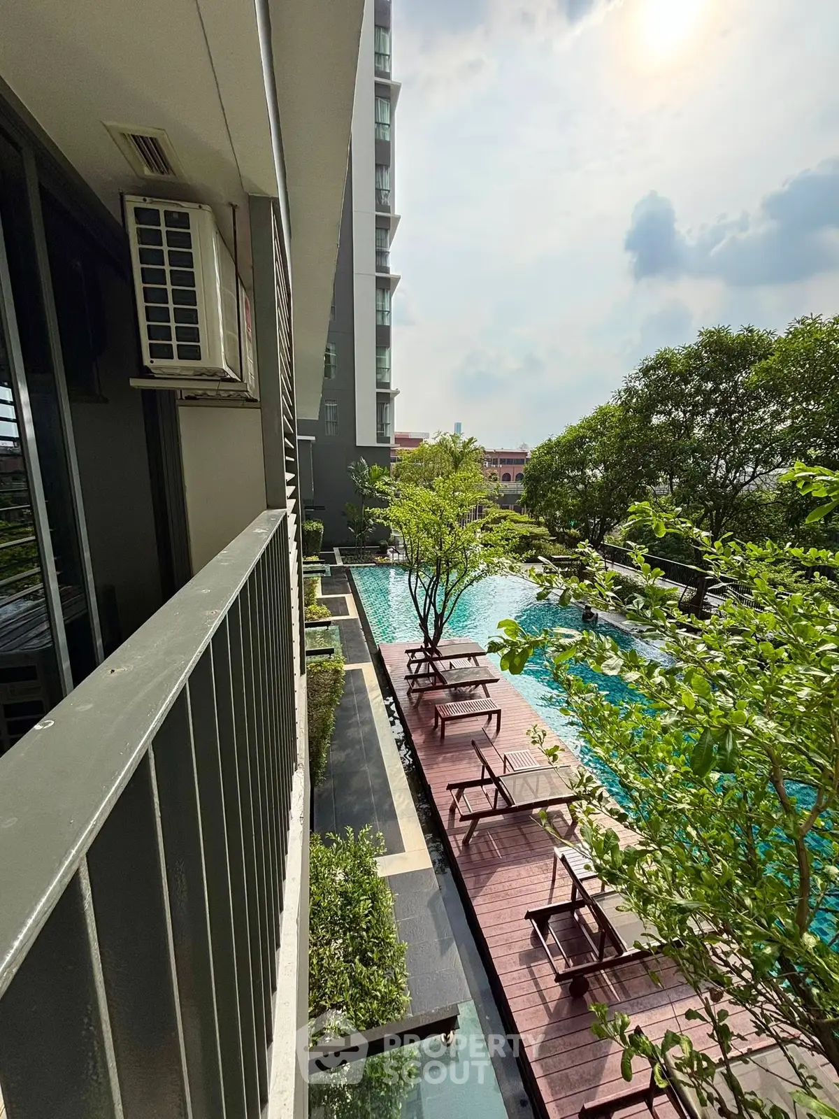 Luxurious apartment with stunning pool view and lush greenery, perfect for relaxation and leisure.