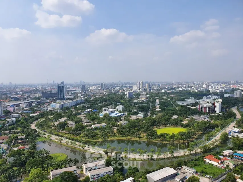 Stunning aerial view of a vibrant cityscape with lush greenery and winding river.