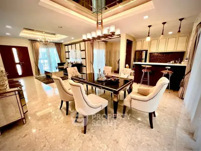 Luxurious open-plan living and dining area with elegant furnishings and modern kitchen.