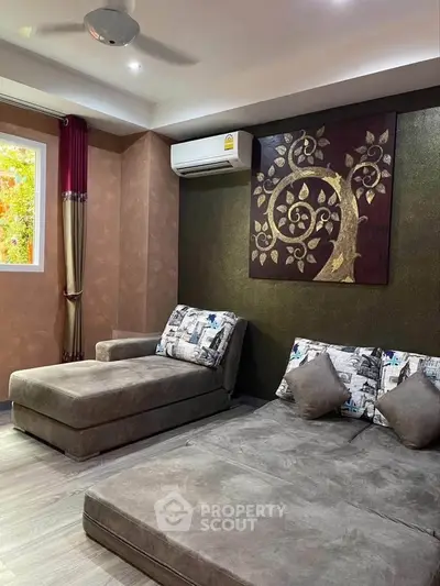 Stylish living room with modern decor, featuring a cozy sectional sofa and elegant wall art, perfect for relaxation.