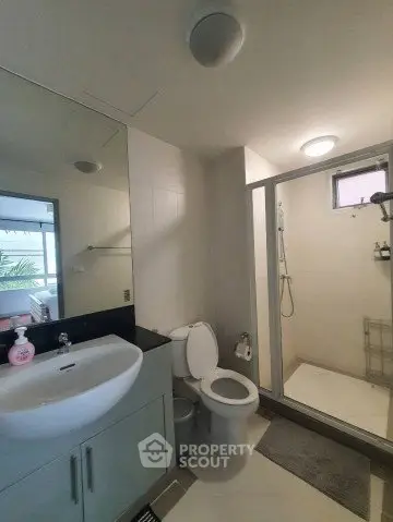 Modern bathroom with sleek fixtures and glass shower enclosure