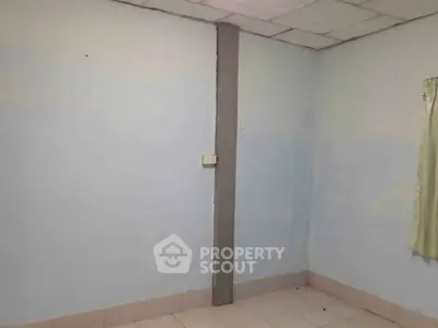 Unfurnished room with tiled floor and light blue walls, ideal for customization.