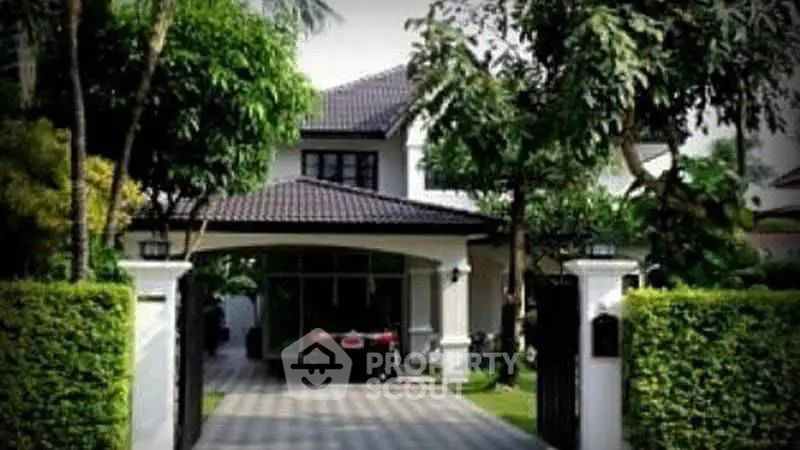 Charming suburban home with lush greenery and spacious driveway