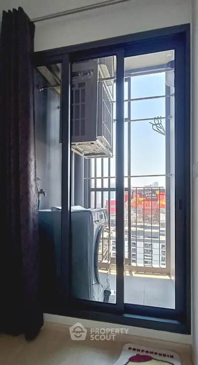 Modern condo balcony with city view and washing machine setup