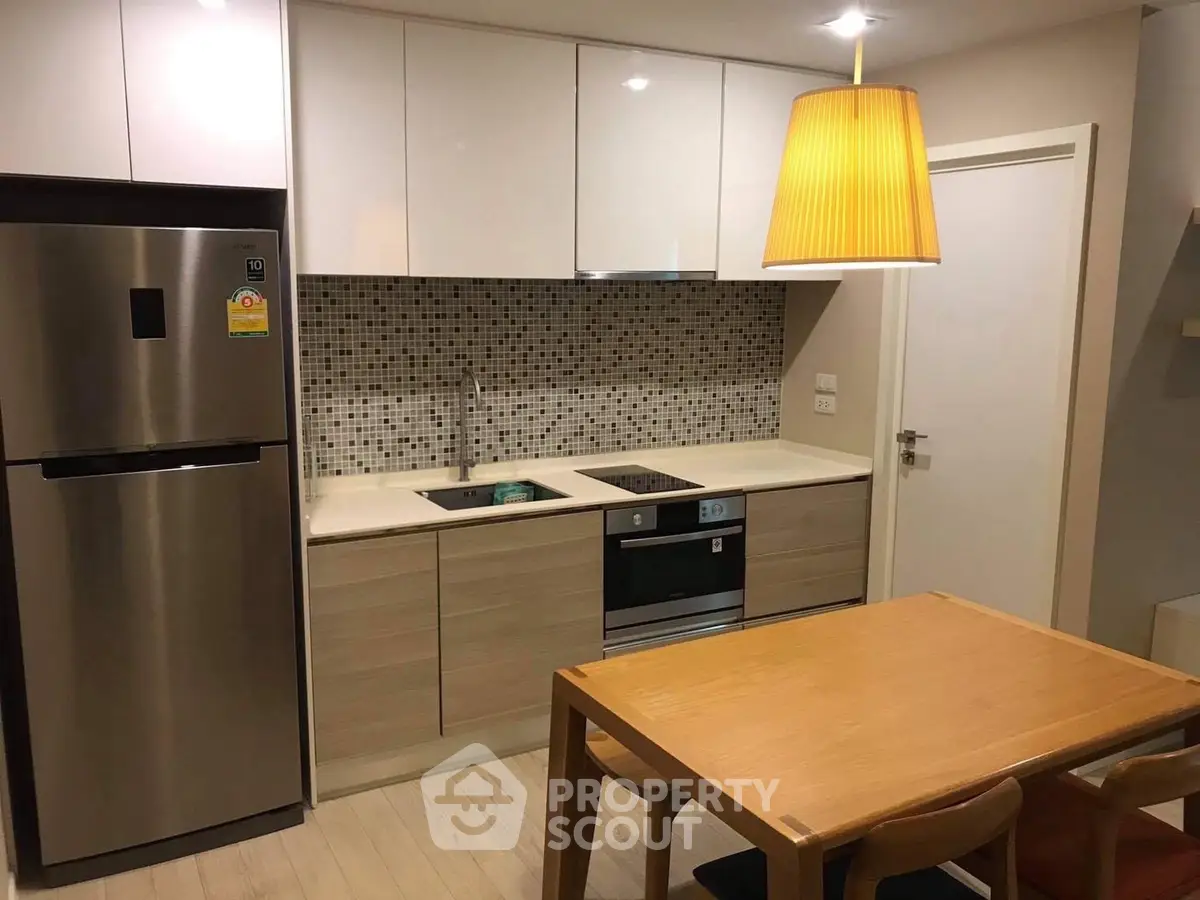 Modern kitchen with sleek appliances and stylish dining area