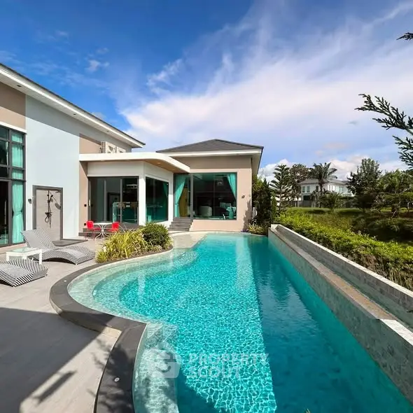Luxurious modern villa with stunning pool and lush garden view, perfect for serene living.