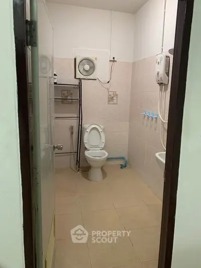 Spacious bathroom with modern amenities and tiled walls