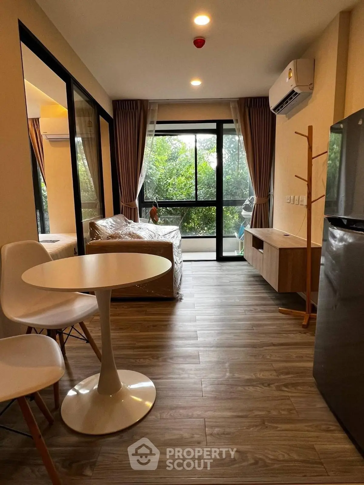 Modern living room with large windows and stylish furniture in a cozy apartment.