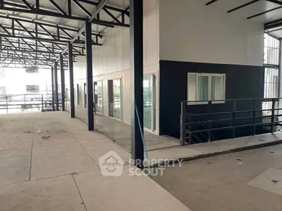 Modern industrial-style interior with metal beams and large windows