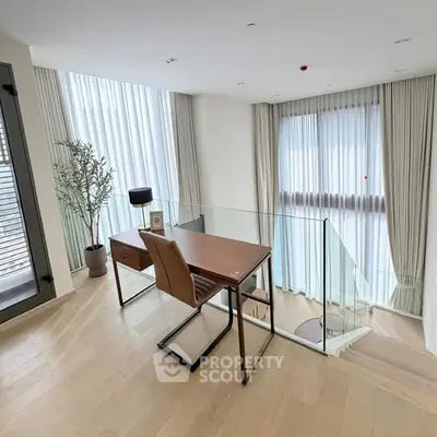Modern study area with elegant desk and chair, featuring floor-to-ceiling windows and stylish decor.