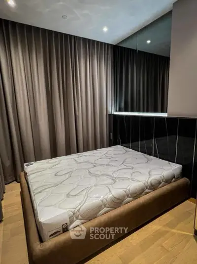 Modern bedroom with stylish bed and elegant curtains in a cozy apartment.