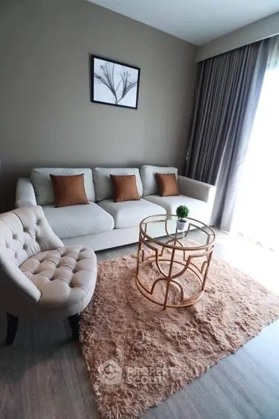 Stylish living room with modern furniture and elegant decor, featuring a cozy sofa and chic coffee table.