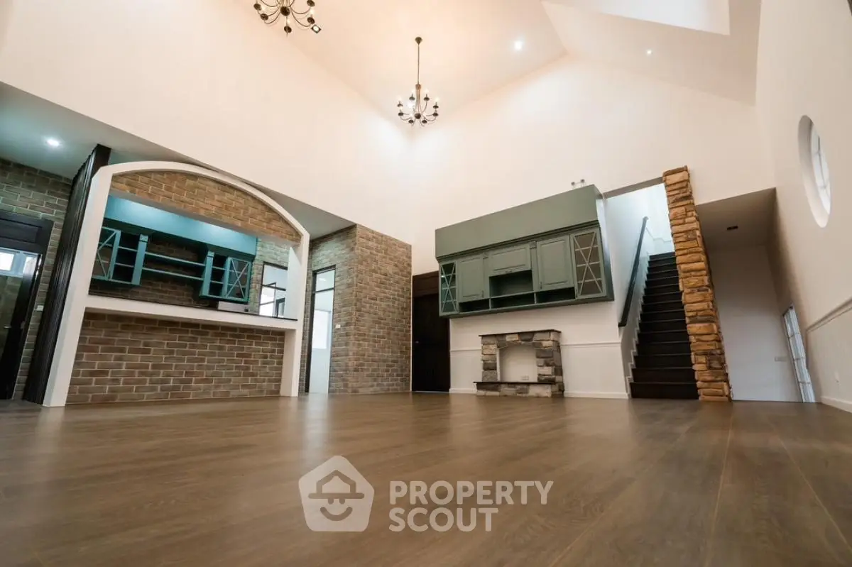 Spacious modern living room with high ceilings and elegant brick accents