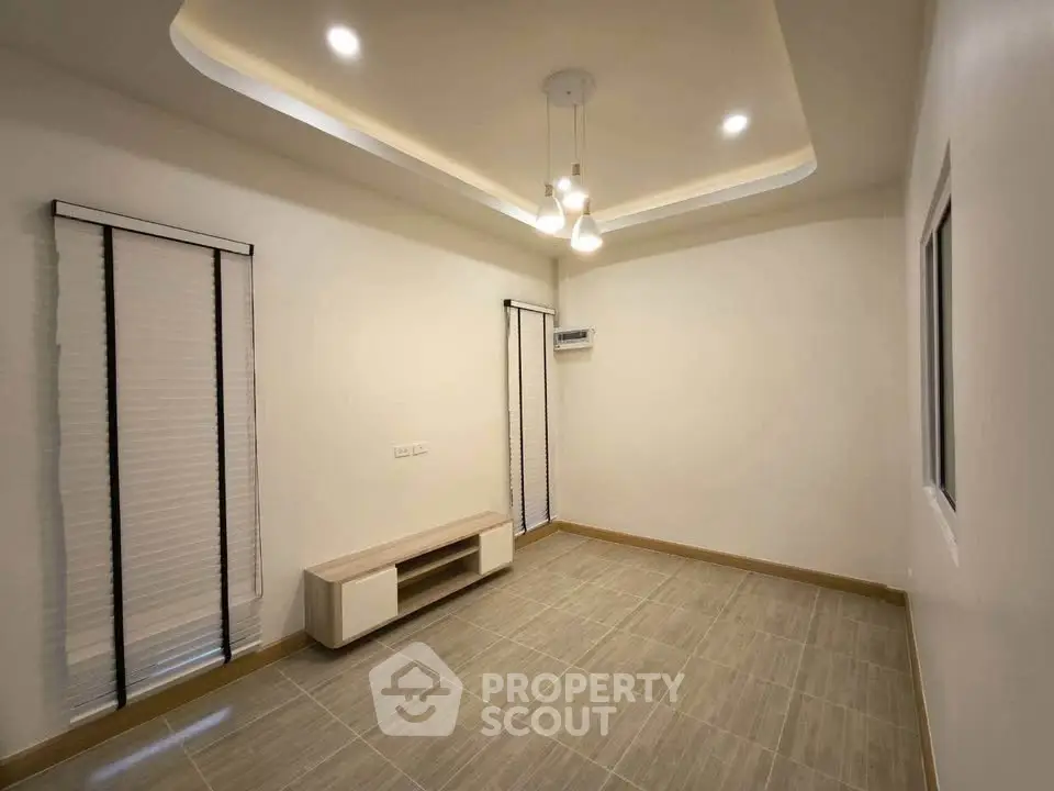 Modern minimalist living room with elegant ceiling lights and sleek flooring.
