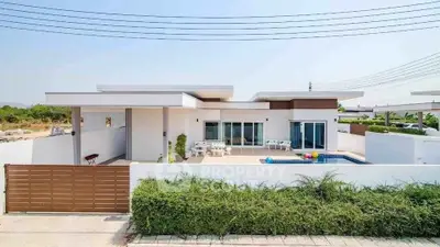 Modern single-story home with pool and spacious patio in a serene neighborhood.