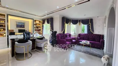 Luxurious living room with elegant purple furniture and stylish decor, perfect for sophisticated gatherings.