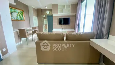 Modern living room with sleek furniture and wall-mounted TV, perfect for relaxation.