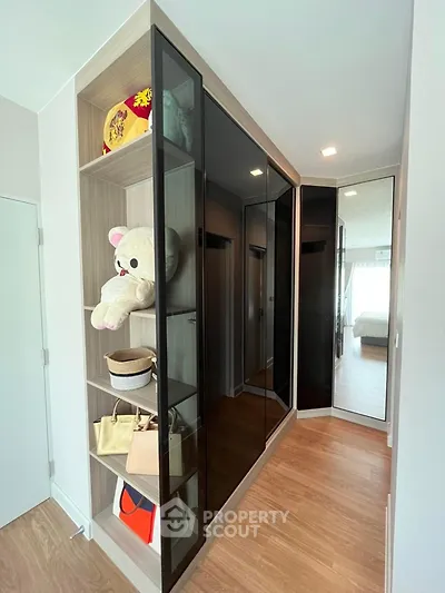 Modern bedroom with sleek built-in wardrobe and wooden flooring