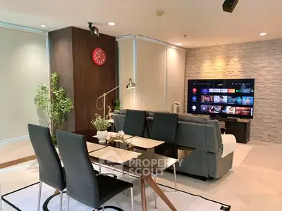 Modern living room with sleek dining area and large TV screen