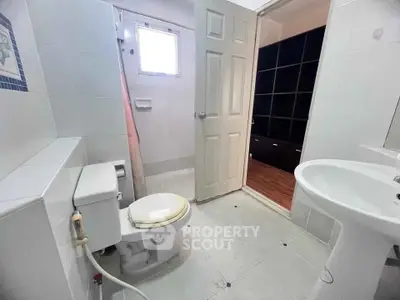 Spacious bathroom with modern fixtures and natural light, ideal for comfortable living.