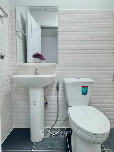 Modern bathroom with sleek white tiles and contemporary fixtures
