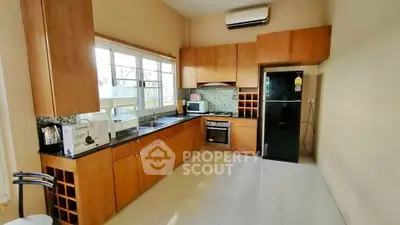 Spacious kitchen with modern appliances and ample storage in a stylish home.