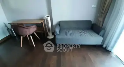 Cozy living room with modern sofa and wooden desk, perfect for urban living.