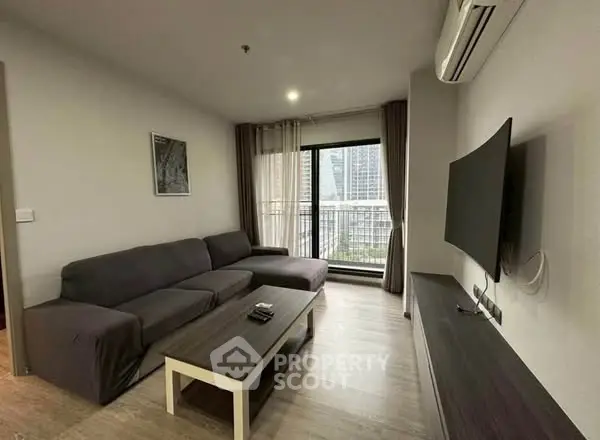 Modern living room with sleek furniture and city view balcony, perfect for urban living.