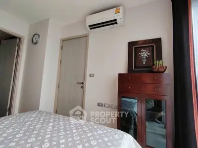 Cozy bedroom with air conditioning and stylish decor in modern apartment.