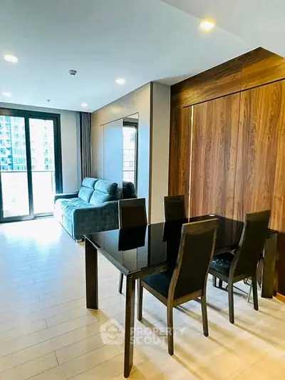 Modern living room with sleek dining area and large windows in a stylish apartment.