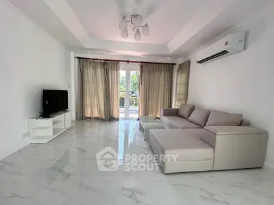 Spacious modern living room with sleek marble flooring and elegant furnishings.