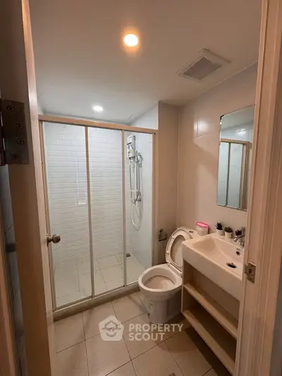 Modern bathroom with glass shower enclosure and sleek fixtures