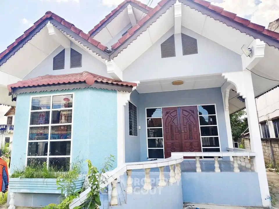 Charming single-story house with unique architectural design and inviting front porch.