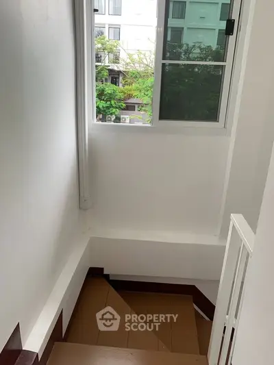 Bright stairwell with window view in modern building