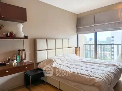 Modern bedroom with city view, featuring elegant decor and large windows for natural light.