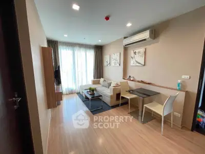 Modern living room with wooden flooring, cozy sofa, and wall-mounted air conditioner in a stylish apartment.