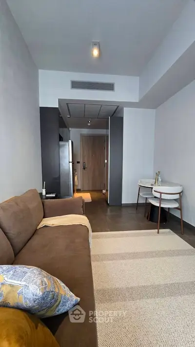 Modern living room with cozy sofa and dining area in stylish apartment