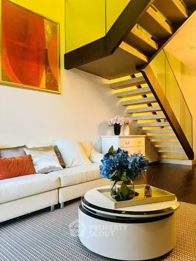 Stylish modern living room with elegant staircase and vibrant decor