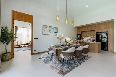 Luxurious open-plan dining and living area with elegant decor and modern kitchen.