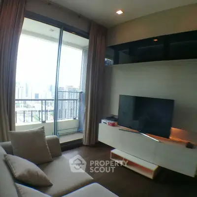 Modern living room with city view balcony, sleek TV setup, and cozy seating area.