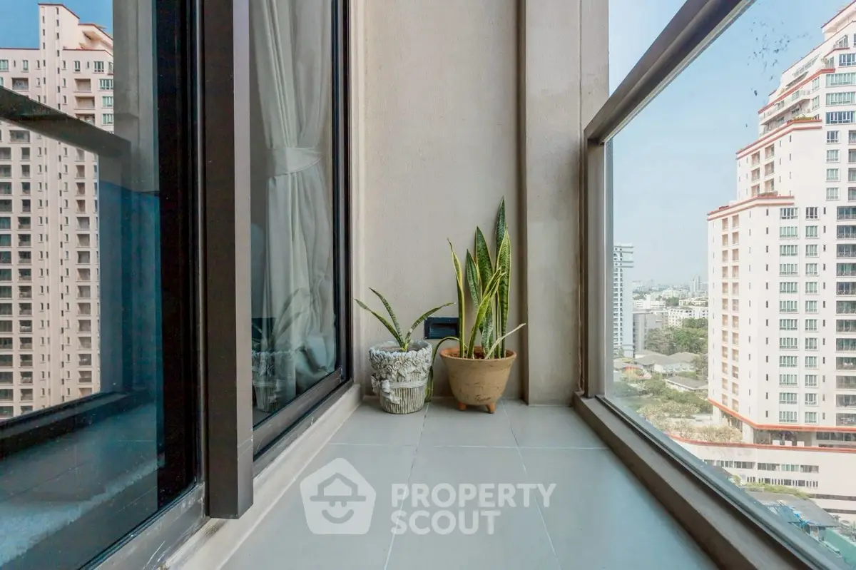 Modern balcony with city view and potted plants, perfect for urban living.